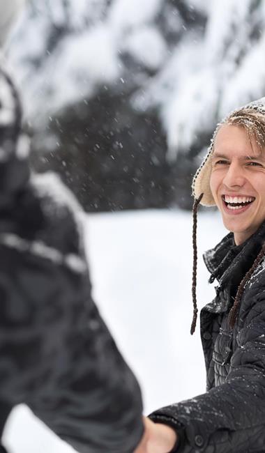 A couple is having fun on snow