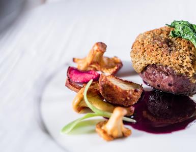 An entrée with meat and mushrooms