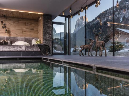 The indoor pool with a view on the Dolomites in winter